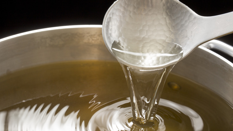 pot of soup stock and silver spoon