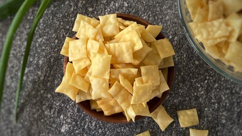fried pieces of wonton skin in wooden bowl