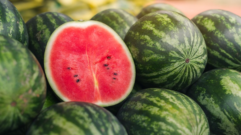 pile of watermelons with one cut in half