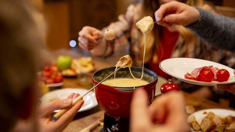 Friends enjoying a pot of fondue