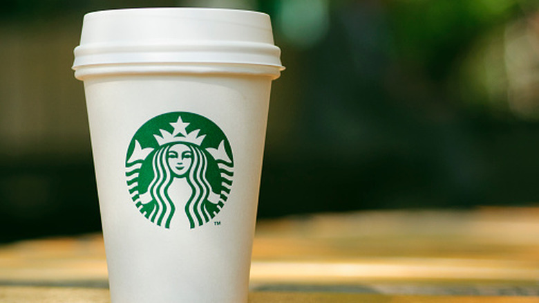 A Starbucks cup sits outside