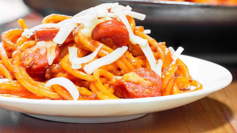 A plate of Filipino spaghetti topped with white cheese