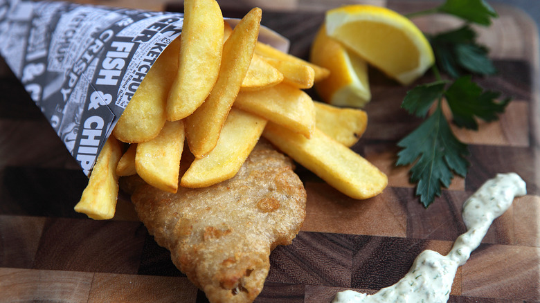 Fish and chips in a cup with fake newspaper print