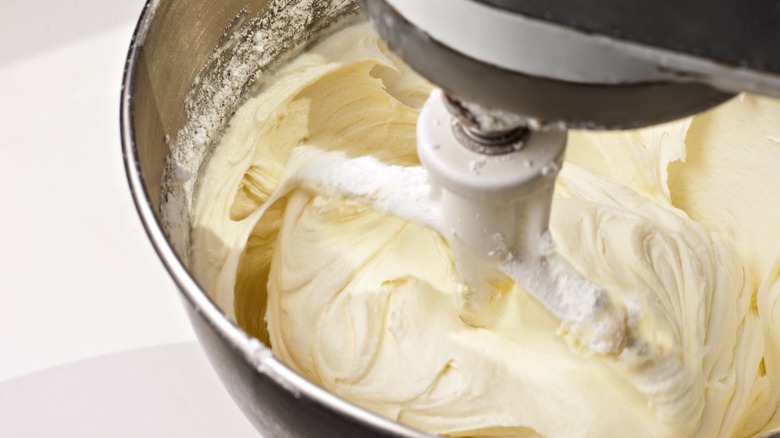 Frosting being mixed in a stand mixer 