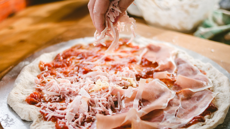 Person making homemade pizza