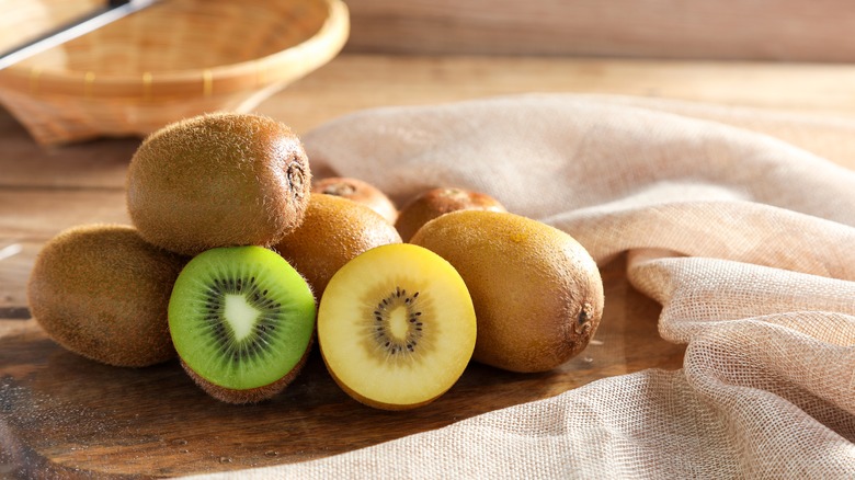 Bowl of kiwis on wooden board