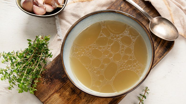 Chicken broth in a bowl reveals its high collagen content