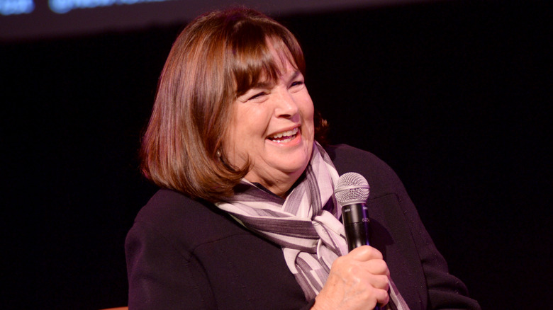 Ina Garten smiling holding a microphone