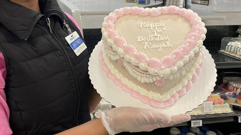 Person holding a Walmart heart cake