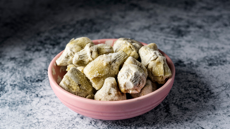 frozen artichoke hearts in pink bowl