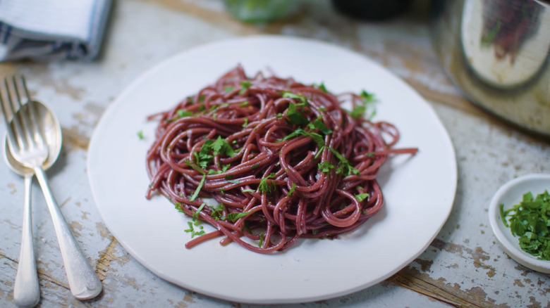 Red wine spaghetti on white plate