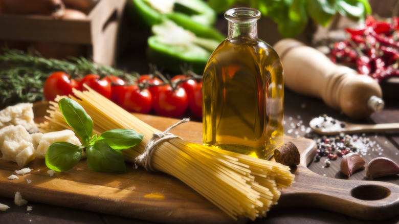 Italian ingredients including pasta, herbs, olive oil