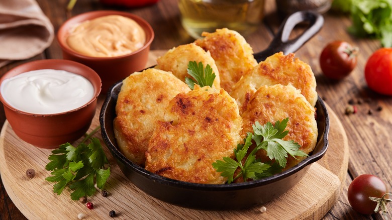 Crispy diner-style hash browns in a bowl with dips