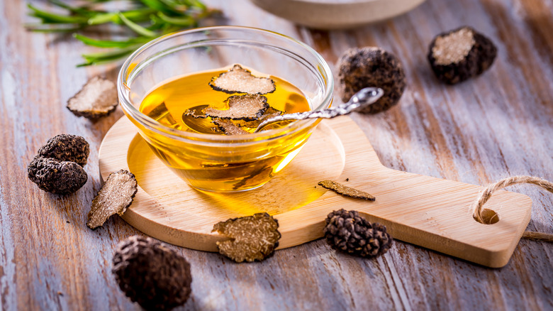 black truffle oil on display on wooden board