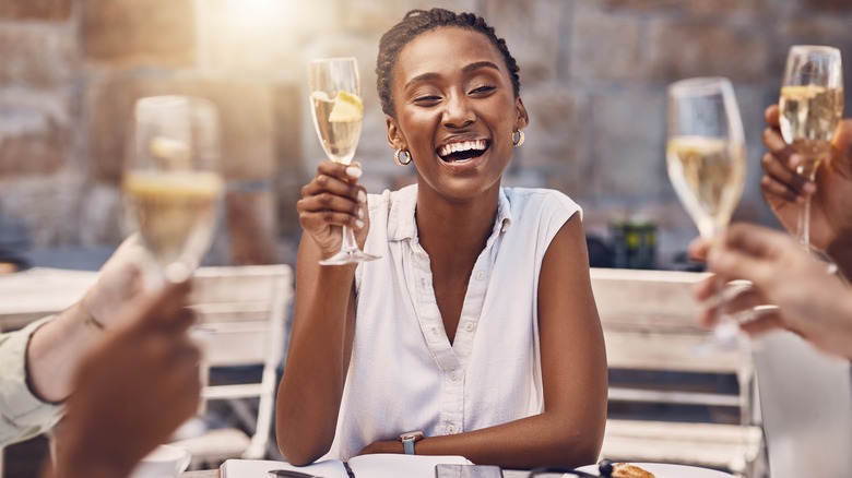 woman proposing a toast with friends