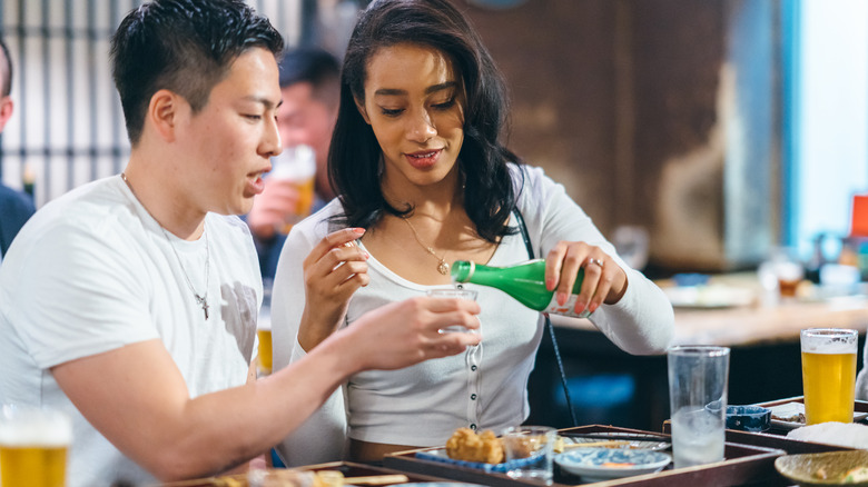 Couple pouring drinks for one another