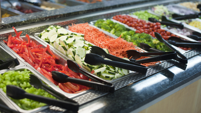 restaurant salad bar with tongs