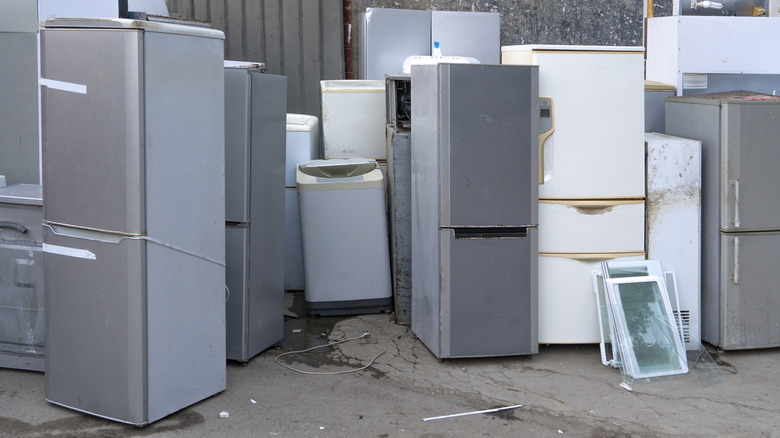 Old, used fridges sit around.