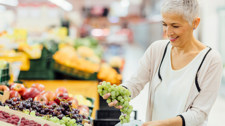 shopping for grapes at supermarket