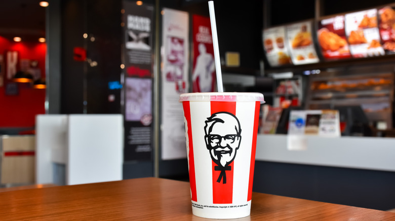 A soft drink with Colonel Harland Sanders's face in a KFC restaurant.