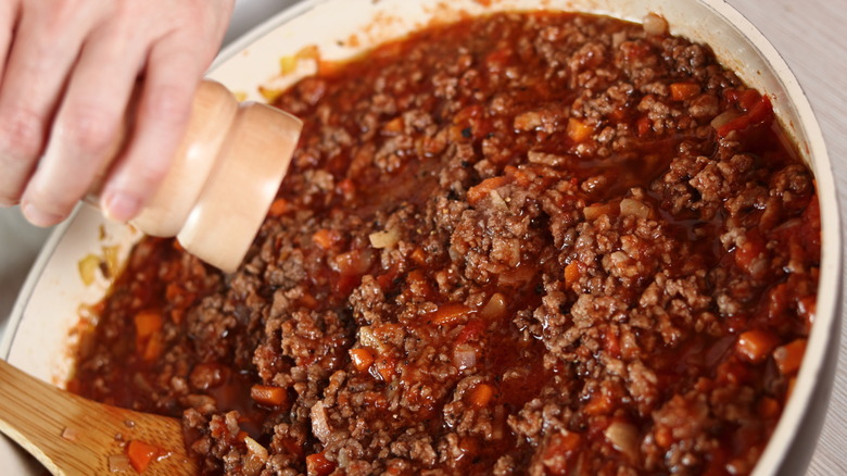 Chef seasoning bolognese
