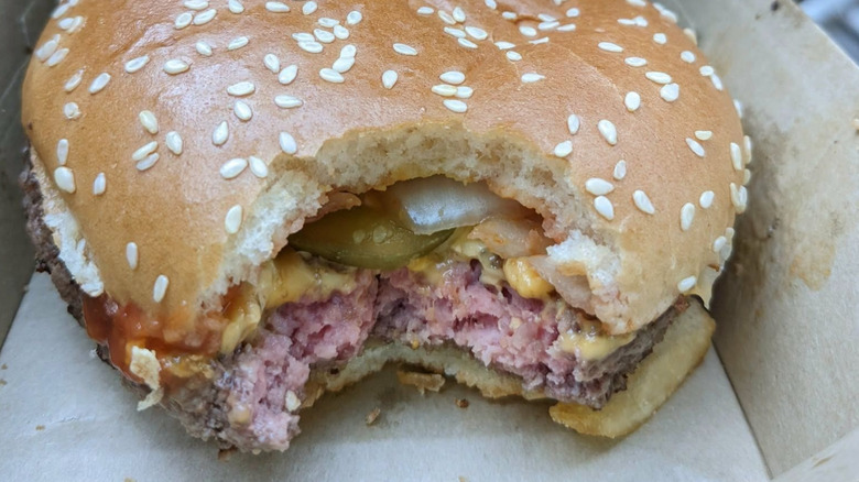 A McDonald's burger with a pink-looking patty.
