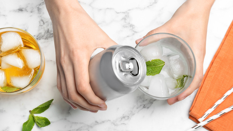 Pouring canned cocktail in glass