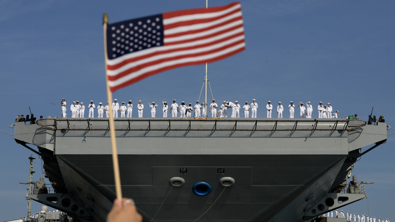 A group of navy sailor on board a ship.