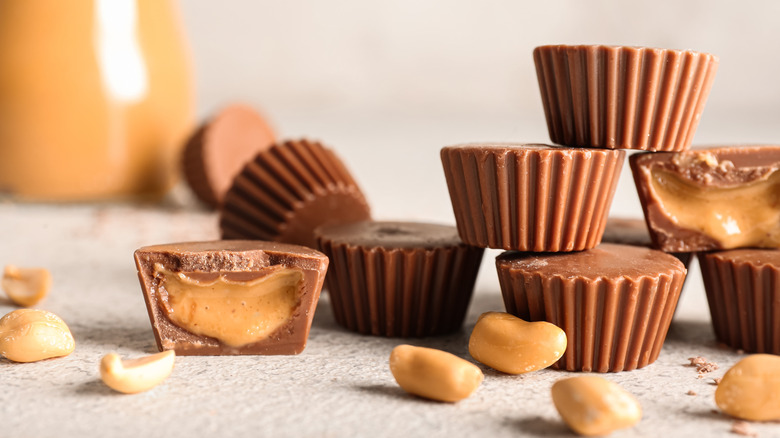 Chocolate peanut butter cups surrounded by peanuts