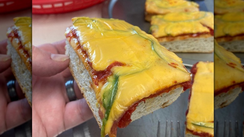 Hand holding a slice of Altoona style pizza
