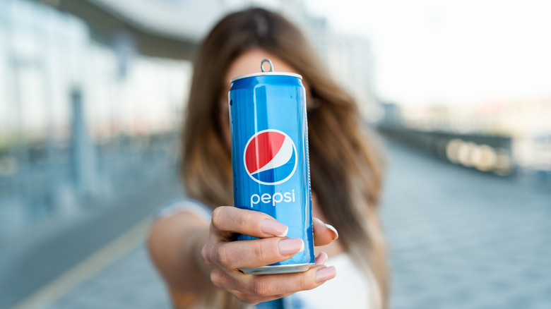 person holding pepsi can