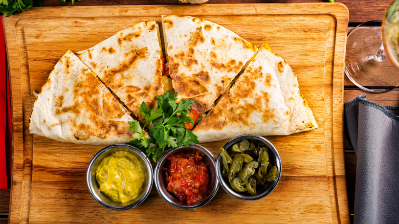 Quesadilla with sauces and pickled jalapenos
