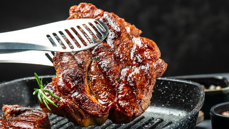 A pork steak with a caramelized, grilled exterior