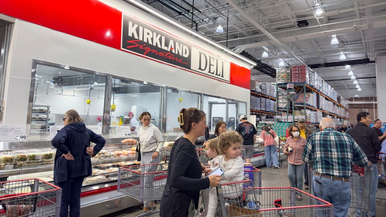 Customers circle a Kirkland signature deli