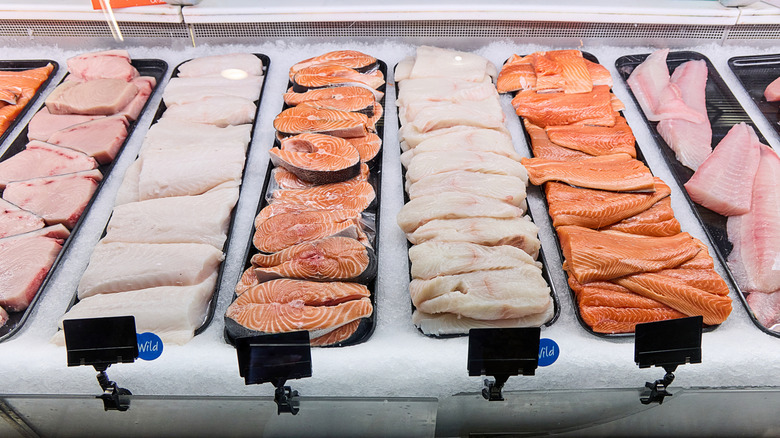 Display case of fresh, raw fish in a grocery store