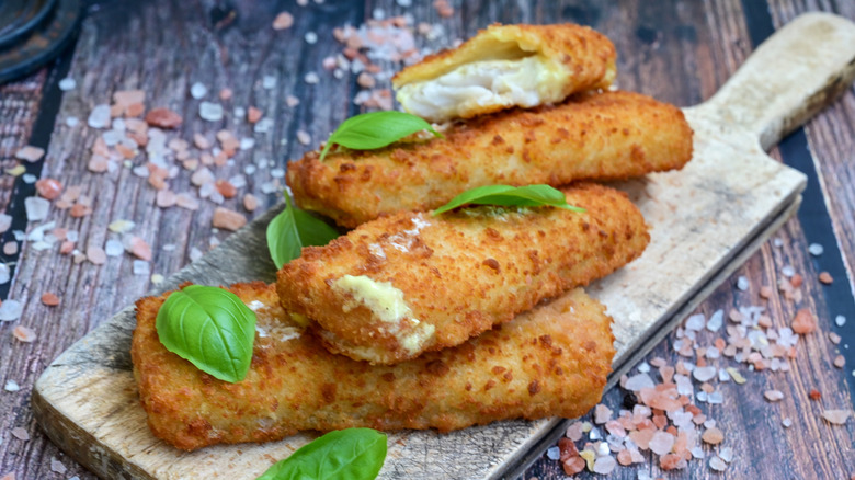 Deep fried fish filets surrounded by salt and topped with basil leaves