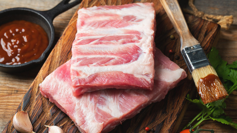 Raw slabs of ribs on a wooden board