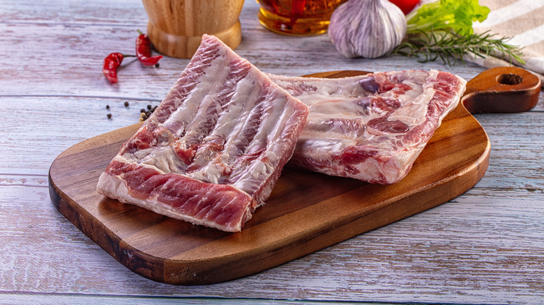 Raw pork ribs on a wooden board