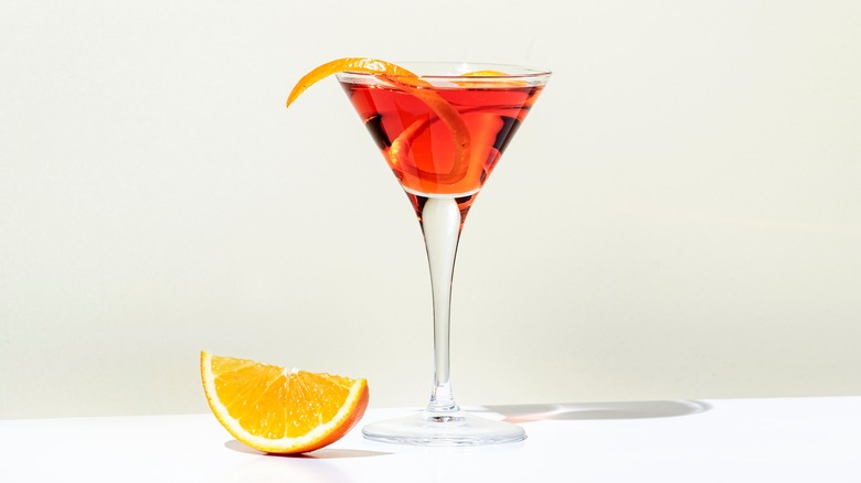 rum cocktail with orange in martini glass