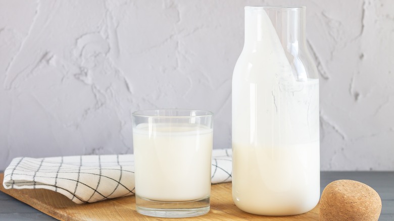 container of sour milk poured into a cup