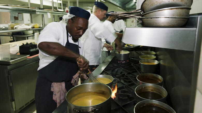 Chef making sauce in restaurant kitchen