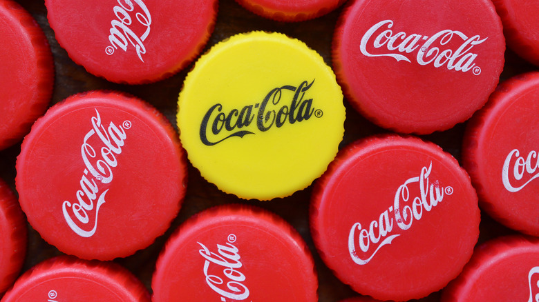 Red and yellow caps on Coca-Cola bottles