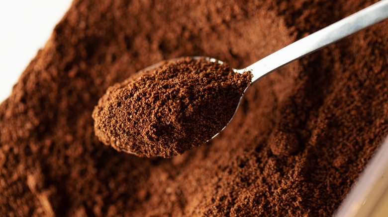 Ground coffee in a spoon.