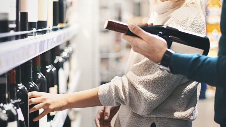 shoppers looking at wine in store