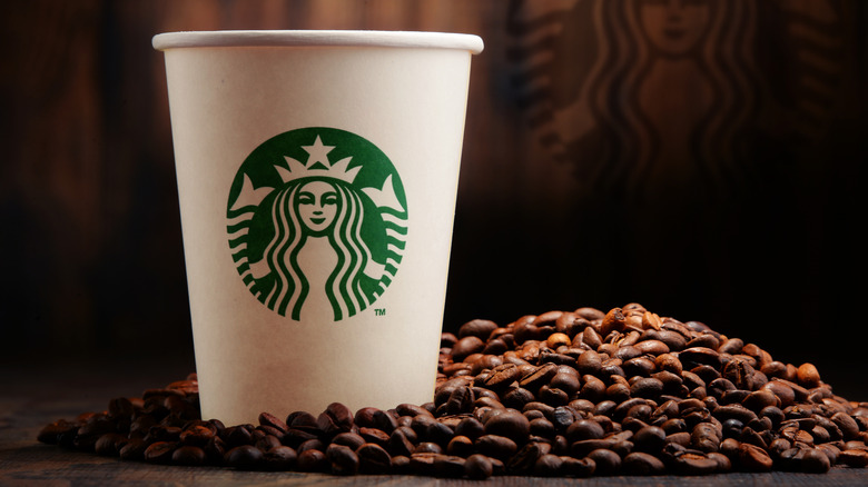 A Starbucks cup with coffee beans
