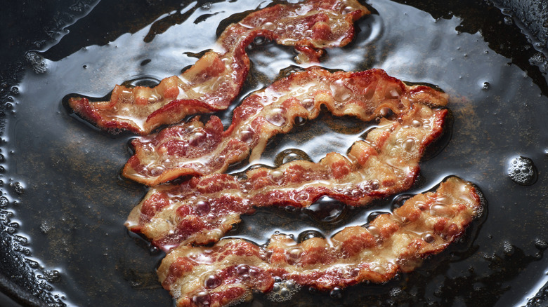 fat being rendered out of bacon strips