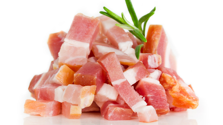 uncooked bacon bits adorned with rosemary