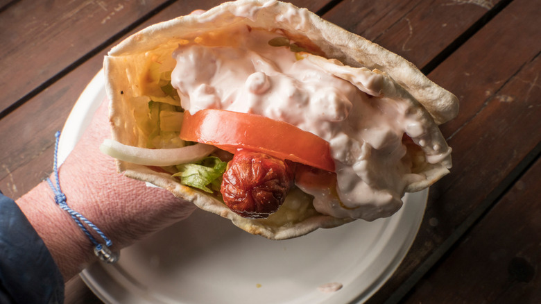 A Swedish-style hot dog, also called tunnbrödsrulle, made with flatbread, mashed potatoes, and shrimp salad