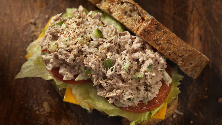 Tuna salad sandwich with pieces of cucumber pickle