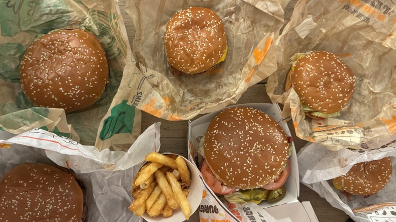Variety of Burger King burgers in wrappers on table